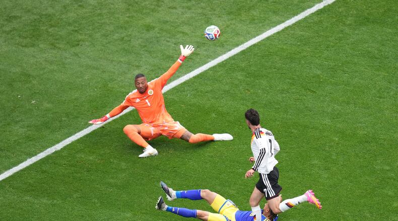 Germany's Kai Havertz (7) scores a goal against Curaçao goalkeeper Eloy Room (1) during the World Cup Group E soccer match between Germany and Curacao in Houston, Sunday, June 14, 2026. (AP Photo/Eric Smith)