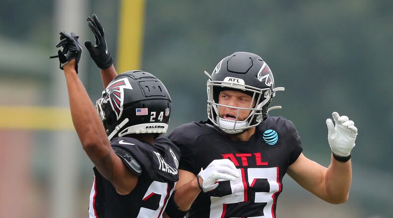 Falcons safety Erik Harris (right) celebrates his interception with cornerback A.J. Terrell (left) during the first day in pads at training camp Tuesday, Aug. 3, 2021, in Flowery Branch. (Curtis Compton / Curtis.Compton@ajc.com)