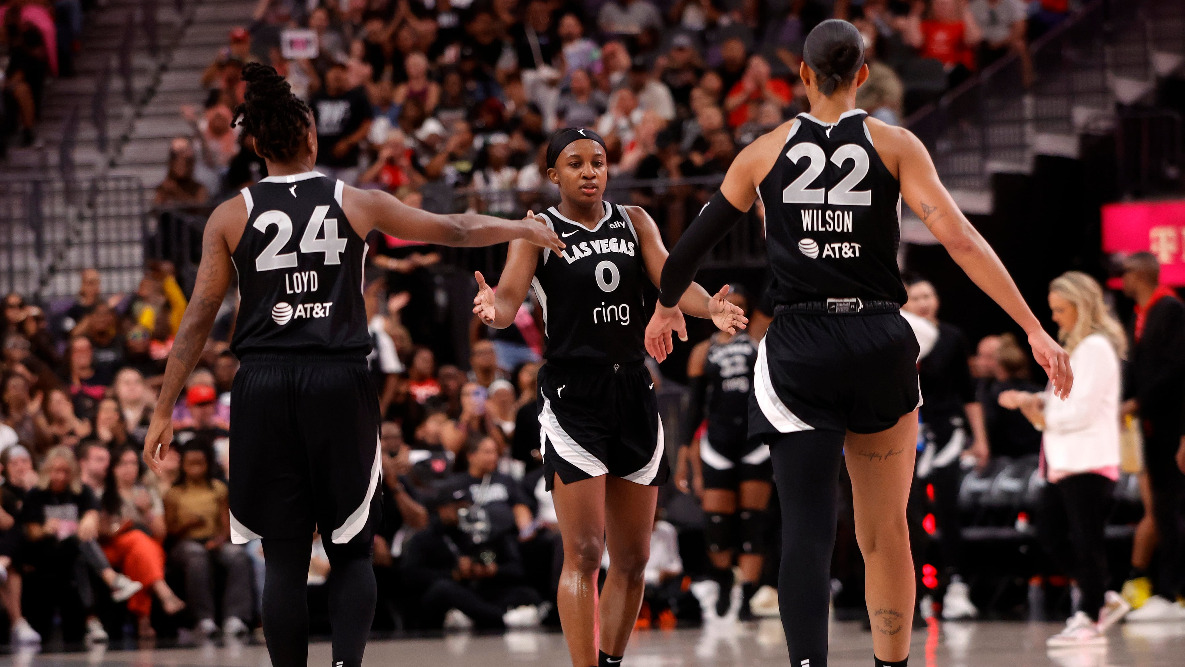 Las Vegas Aces guard Jackie Young (0) is congratulated by guard Jewell Loyd (24) and center A'ja Wilson (22) after making a 3-point basket against the Chicago Sky during the first half of a WNBA basketball game Tuesday, Sept. 9, 2025, in Las Vegas. (Steve Marcus/Las Vegas Sun via AP)