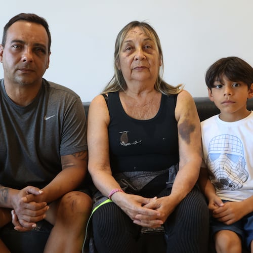 Grian Serrano, left, his mother, Ingrid Rochabrun, and his son, Gael, sit at the home where they are staying with relatives in Caracas, Venezuela, after surviving the back-to-back earthquakes that destroyed their apartment building in Caraballeda, Monday, June 29, 2026. Serrano also survived the 1999 mudslides that struck La Guaira. (AP Photo/Pedro Mattey)
