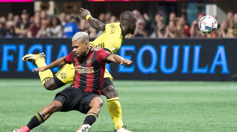 Atlanta United forward Josef Martinez (7) and Columbus Crew defender Jonathan Mensah (4) fight over the ball during an MLS game at Mercedes-Benz Stadium, Thursday, Oct. 26, 2017, in Atlanta. BRANDEN CAMP/SPECIAL