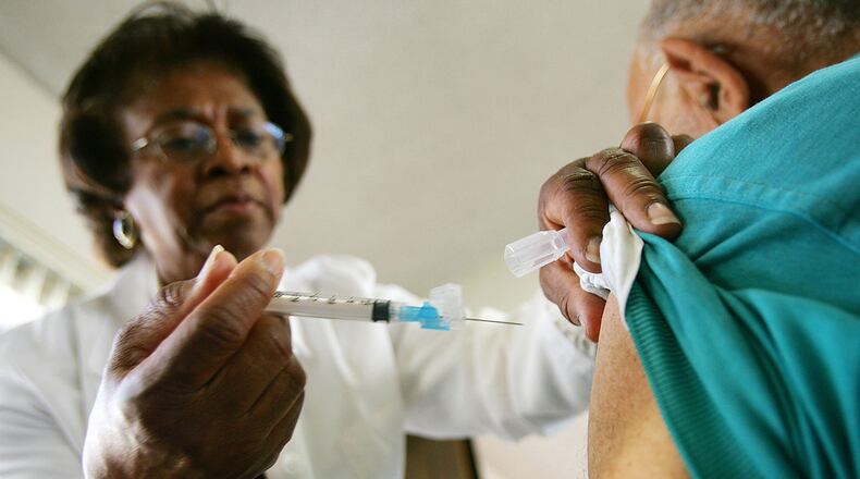 LOS ANGELES, CA - OCTOBER 26: Emily Moore administers an inoculation as free flu shots are given to people over 50 by the Los Angeles County Department of Health Services on October 26, 2005 in Los Angeles, California. An estimated 60 million flu shots will be given in the United States this season. (Photo by David McNew/Getty Images)