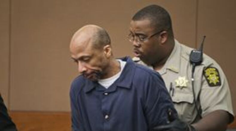 In this Jan. 11, 2013, file photo, Fulton County Sheriff A. Burgess leads Floyd Palmer into a courtroom. JOHN SPINK / JSPINK@AJC.COM
