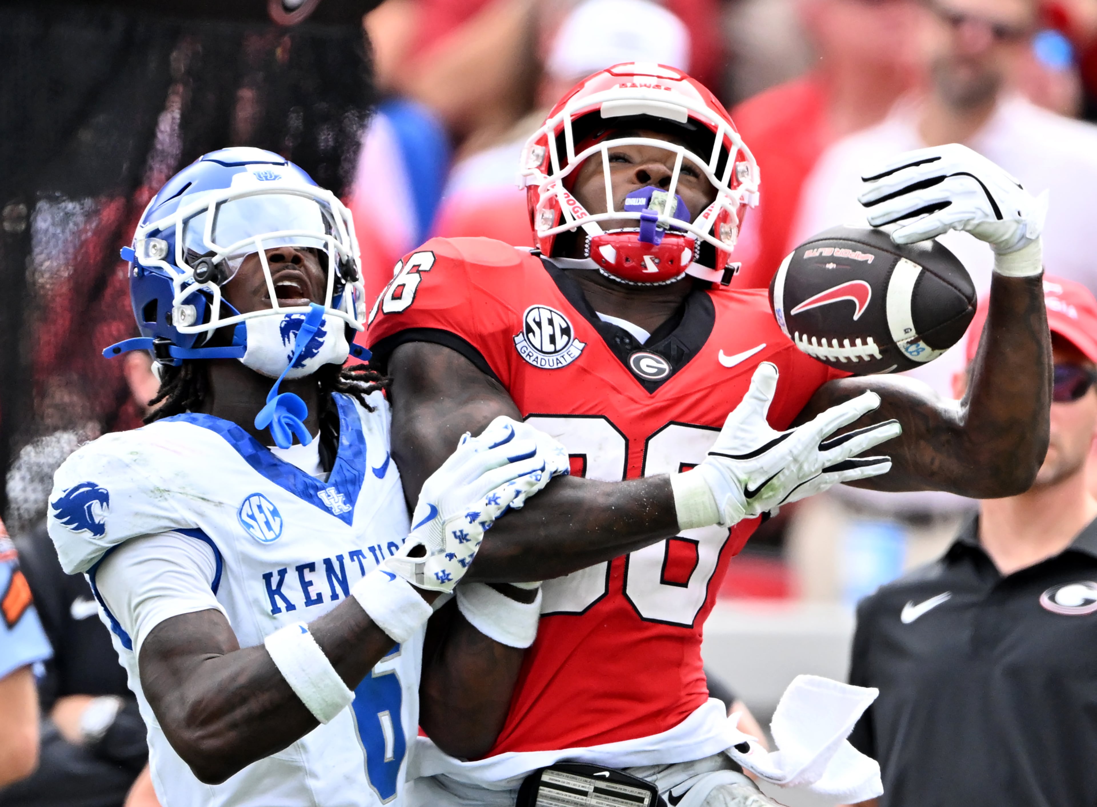 Georgia wide receiver Dillon Bell (86) makes a catch over Kentucky defensive back Jq Hardaway (6) during the second half in a NCAA college football game at Sanford Stadium, Saturday, October 4, 2025, in Athens. Georgia won 35 -14 over Kentucky. (Hyosub Shin / AJC)