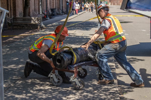 Workers prep one of the Revolutionary War cannons recovered from the Savannah River in 2021 for installation in the Savannah History Museum's new "Loyalists & Liberty" exhibit. (Courtesy of Coastal Heritage Society)