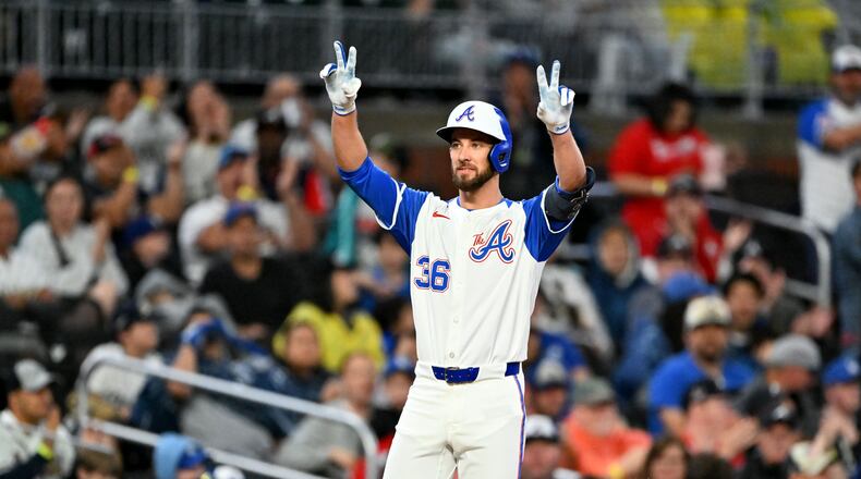 Braves outfielder Eli White celebrates during the second inning of Saturday's game at Truist Park in Atlanta. His offense has surpassed any expectations, and his speed has proven valuable. (Hyosub Shin/AJC)