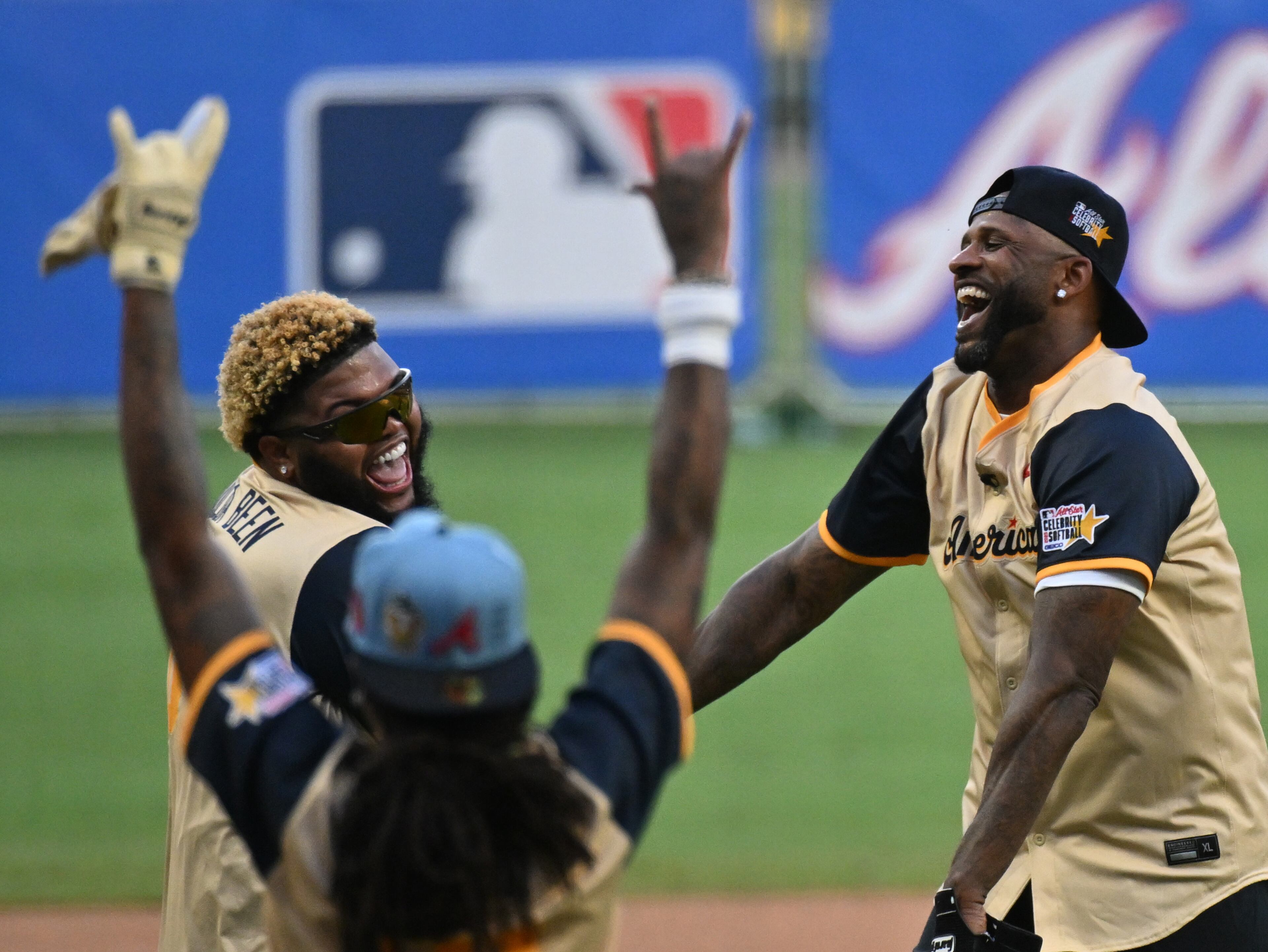 CC Sabathia (right), Yankees Legend & Hall of Famer, celebrates with American League teammates after hitting a home run during the MLB All-Star Celebrity Softball Game at Truist Park, Saturday, July 12, 2025, in Atlanta. (Hyosub Shin / AJC)