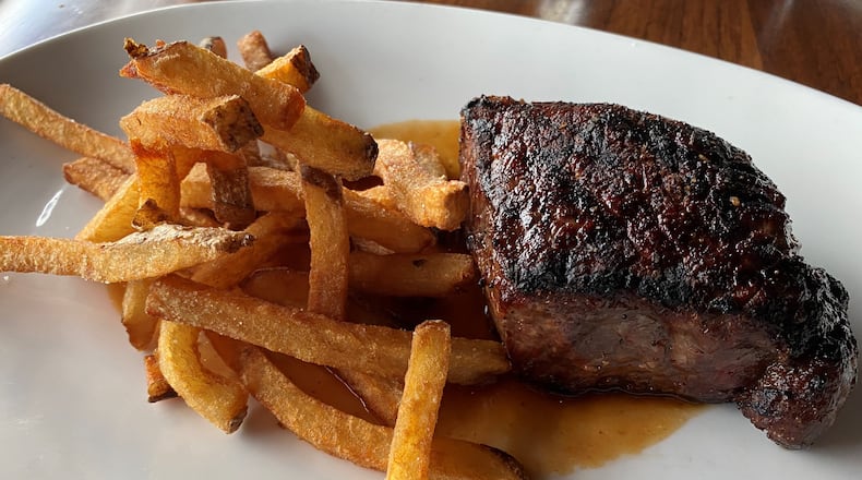 Kaiser’s Chophouse in Sandy Springs offers an 8-ounce prime New York strip steak with hand-cut fries and garlic-pepper dust. Bob Townsend for The AJC