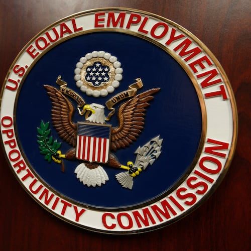FILE - The emblem of the U.S. Equal Employment Opportunity Commission (EEOC) is displayed on a podium in Denver on Feb. 16, 2016. (AP Photo/David Zalubowski, File)