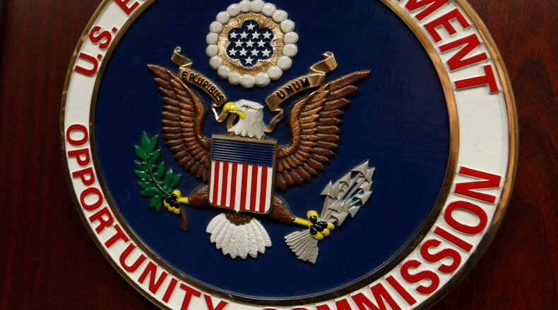 FILE - The emblem of the U.S. Equal Employment Opportunity Commission (EEOC) is displayed on a podium in Denver on Feb. 16, 2016. (AP Photo/David Zalubowski, File)