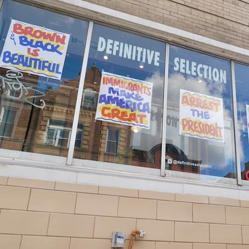FILE - A bicyclist passes Definitive Selection clothing store, one of many businesses in the predominantly Latino neighborhood that has seen a slowdown in foot traffic since President Donald Trump's threats of a federal law enforcement intervention, Sept. 5, 2025, in Chicago. (AP Photo/Mark Vancleave, File)