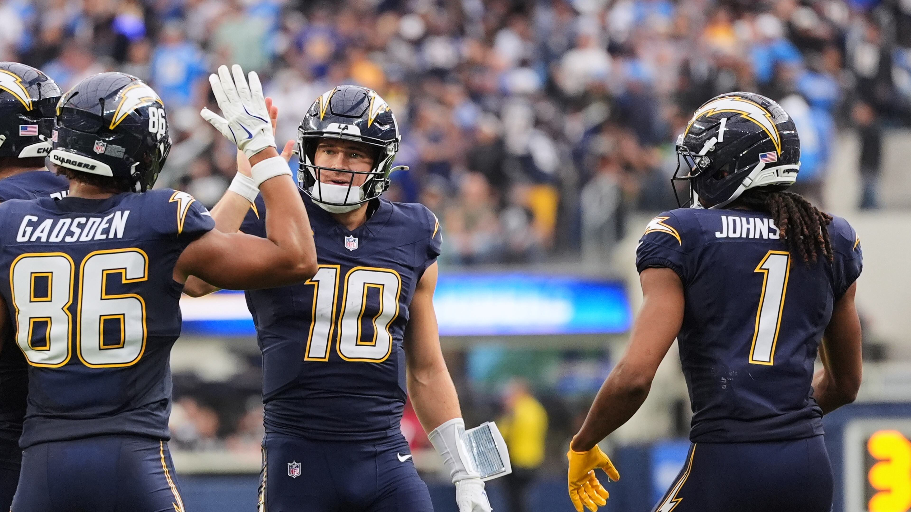 Los Angeles Chargers quarterback Justin Herbert (10) celebrates with tight end Oronde Gadsden II (86) after throwing a touchdown during the second half of an NFL football game against the Las Vegas Raiders, Sunday, Nov. 30, 2025, in Inglewood, Calif. (AP Photo/Jae C. Hong)