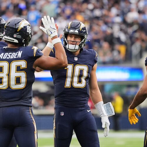 Los Angeles Chargers quarterback Justin Herbert (10) celebrates with tight end Oronde Gadsden II (86) after throwing a touchdown during the second half of an NFL football game against the Las Vegas Raiders, Sunday, Nov. 30, 2025, in Inglewood, Calif. (AP Photo/Jae C. Hong)