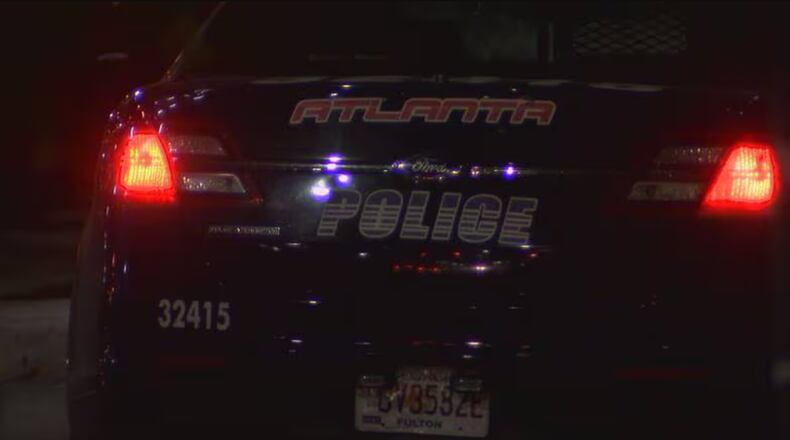An Atlanta police patrol car at the scene of a fatal shooting on Huff Road.