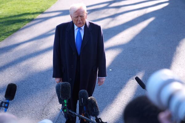 President Donald Trump speaks with reporters on the South Lawn of the White House before boarding Marine One en route to New Jersey, Friday, Mar. 21, 2025, in Washington. (AP Photo/Mark Schiefelbein)