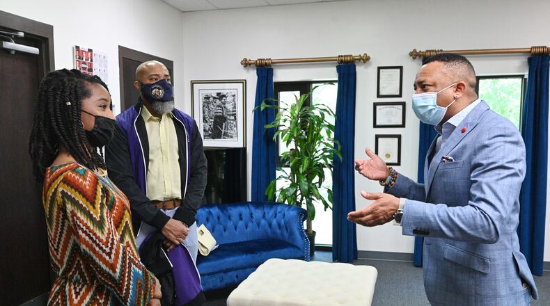 Morris Brown's president Dr. Kevin E. James (right) talks to incoming student Nala Miller (left) as her father and Morris Brown alumnus Jeffery Miller looks at Morris Brown College on Wednesday, April 21, 2021. (Hyosub Shin / Hyosub.Shin@ajc.com)