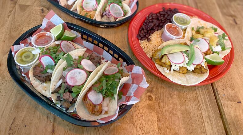 Dos Burros offers 10 tacos, each priced at $5. The $15 taco special brings a choice of two tacos with black or refried beans and Mexican rice. Ligaya Figueras/ligaya.figueras@ajc.com