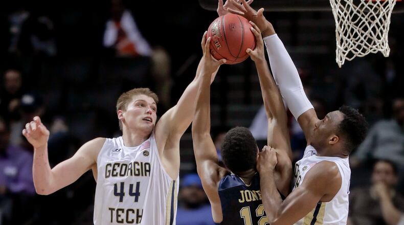 Georgia Tech center Ben Lammers (44) and guard Josh Okogie (5) block a shot attempt by Pittsburgh guard Chris Jones (12) during the second half of an NCAA college basketball game in the first round of the ACC tournament, Tuesday, March 7, 2017, in New York. Pittsburgh won 61-59. (AP Photo/Julie Jacobson)
