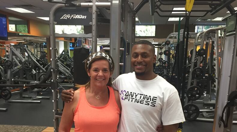 Janet Stallings at 145 pounds in October. With her is Justin Hunt, her personal trainer at Anytime Fitness in Towne Lake. (Justin Hunt)