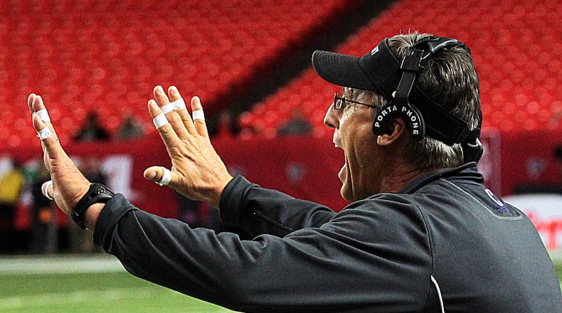 Calvary Day School (Savannah) head coach Mark Stroud instructs his players in their game against the Aquinas High School (Augusta) Fightin' Irish in the GHSA Football A-Private State Championship at the Georgia Dome in Atlanta on Friday December 13th, 2013.
