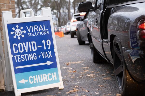 In this file photo, People line up for Covid testing at the Viral Solutions drive-through testing site in Decatur last week. Ben Gray for the Atlanta Journal-Constitution