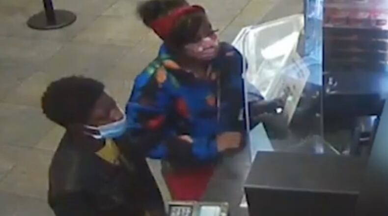 Atlanta police arrested two suspects after a woman was shot inside a movie theatre.