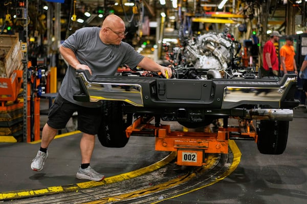 Vehicle assembly technician Kevin Zepernick works on a 2025 Ford Expedition during a media tour to launch the 2025 Ford Expedition at the Ford Motor Company Kentucky Truck Plant, Wednesday, April 30, 2025, in Louisville, Ky. (AP Photo/Carolyn Kaster)
