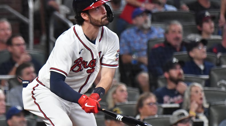 Braves shortstop Dansby Swanson (7) hits an RBI triple to score Atlanta Braves catcher Travis d'Arnaud (16) in the 4th inning Thursday, Sept. 30, 2021, at Truist Park in Atlanta. (Hyosub Shin / Hyosub.Shin@ajc.com)