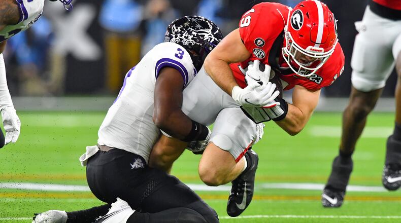 Georgia tight end Brock Bowers runs for a first down against TCU safety Mark Perry (3) during the first half of the College Football Playoff National Championship at SoFi Stadium in Los Angeles on Monday, Jan. 9, 2023. (Hyosub Shin / Hyosub.Shin@ajc.com)