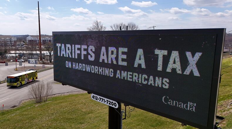 Digital billboards like this one in Pennsylvania earlier this month that flash anti-tariff messages are going up in metro Atlanta. (AP Photo/Gene J. Puskar)