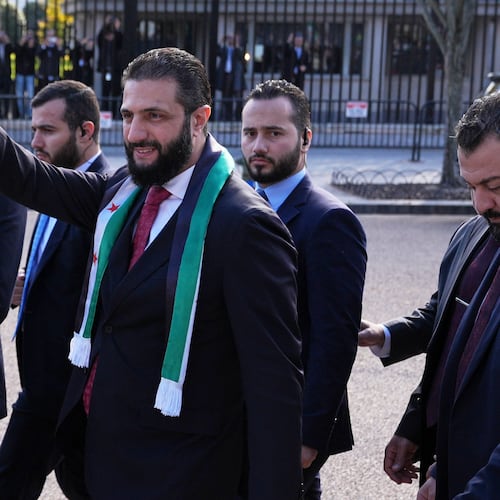 Syria's President Ahmed al-Sharaa waves as he greets supporters outside of the White House, Monday, Nov. 10, 2025, in Washington, following a meeting with President Donald Trump. (AP Photo/Jacquelyn Martin)