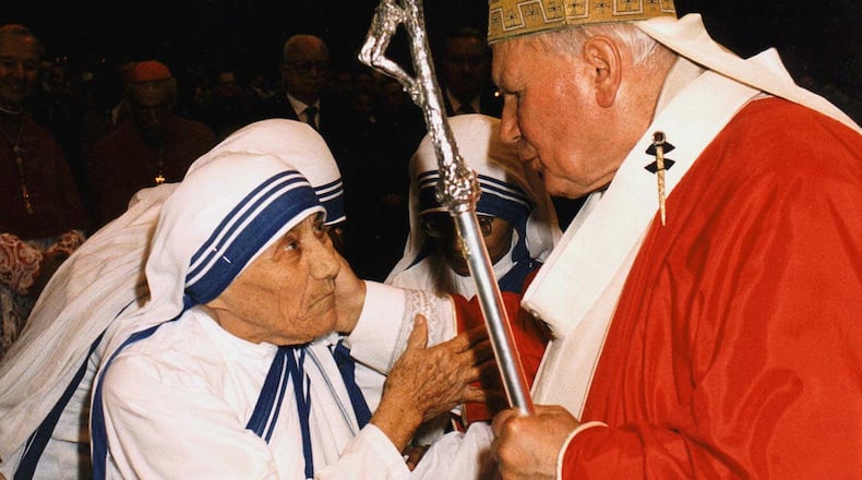 In this June 29, 1997, photo, Pope John Paul II greets Mother Teresa of Calcutta as they meet in St. Peter’s Basilica at the Vatican. Mother Teresa, who died Sept. 5, 1997, will be made a saint on Sept. 4, 2016. Pope Francis set the canonization date on March 15, 2016, paving the way for the nun who cared for the poorest of the poor to become the centerpiece of his yearlong focus on the Catholic Church’s merciful side. L’OSSERVATORE ROMANO/FILE POOL PHOTO VIA AP