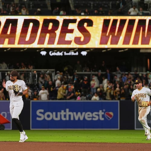San Diego Padres right fielder Fernando Tatis Jr., left, and left fielder Ramón Laureano celebrate after the Padres defeated the Seattle Mariners 5-2 in a baseball game Thursday, April 16, 2026, in San Diego. (AP Photo/Gregory Bull)