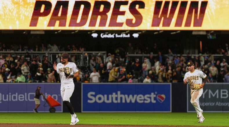 San Diego Padres right fielder Fernando Tatis Jr., left, and left fielder Ramón Laureano celebrate after the Padres defeated the Seattle Mariners 5-2 in a baseball game Thursday, April 16, 2026, in San Diego. (AP Photo/Gregory Bull)