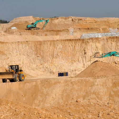FILE - Workers use machinery to dig at a rare earth mine in Ganxian county in central China's Jiangxi province on Dec. 30, 2010. (Chinatopix via AP, File)