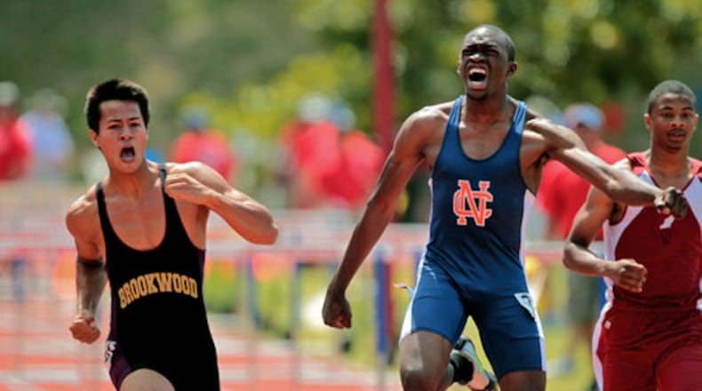 Brookwood's Paul Beaty, left, bests North Cobb's Levi Josephs to win the Class AAAAA 110 meter high hurdles final. Beaty won in 14.35, beating Joseph by .04 seconds.
