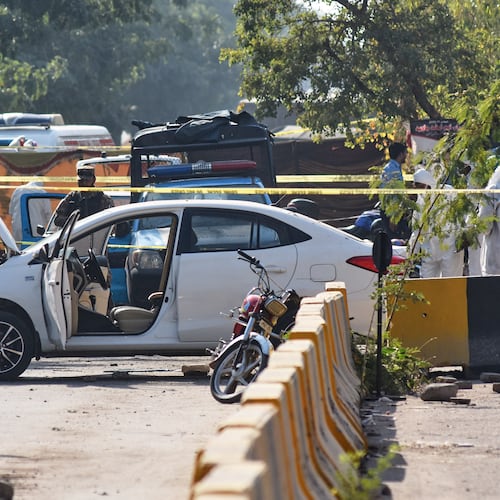 Pakistan's investigators examine the site following a suicide bombing outside the gates of a district court, in Islamabad, Pakistan, Tuesday, Nov. 11, 2025. (AP Photo/W.K. Yousufzai)