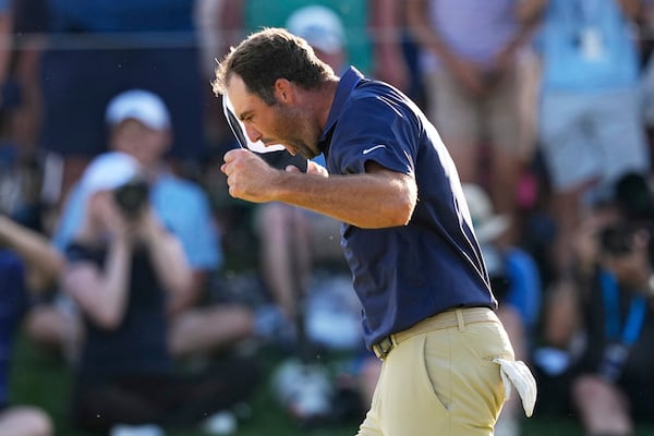 Scottie Scheffler celebrates after winning the PGA Championship golf tournament at the Quail Hollow Club, Sunday, May 18, 2025, in Charlotte, N.C. (AP Photo/David J. Phillip)