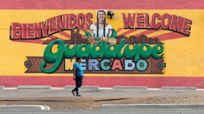A person walks past a mural promoting Guadalupe, Ariz., May 19, 2026. (AP Photo/Ross D. Franklin)