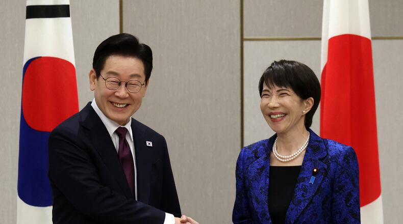 Japan's Prime Minister Sanae Takaichi, right, shakes hands with South Kore's President Lee Jae Myung at the start of their meeting in Nara, western Japan Tuesday, Jan. 13, 2026. (Issei Kato/Pool Photo via AP)