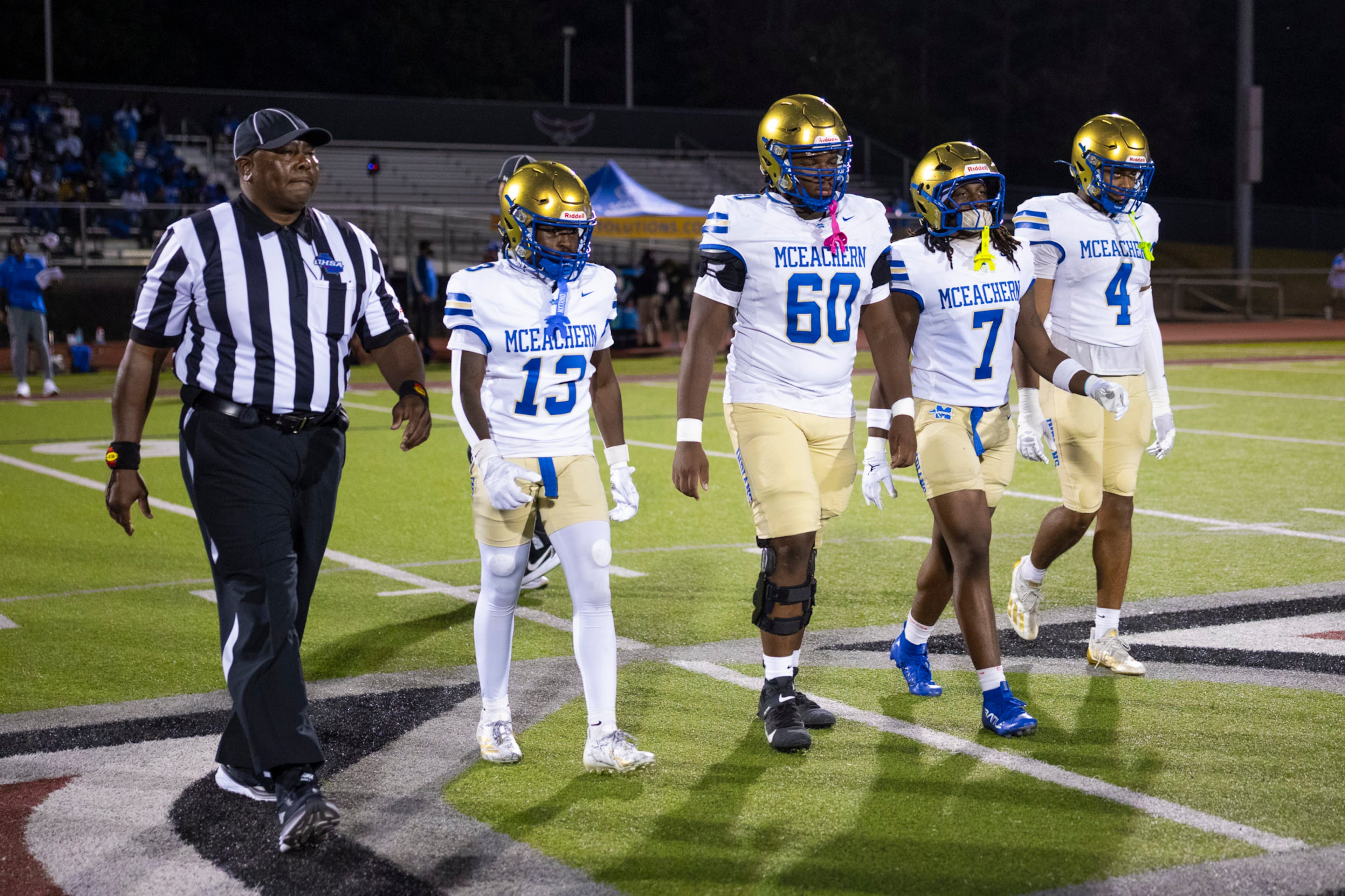 McEachern captains go to the center for the coin toss against Hillgrove at Cobb Energy Hillgrove Stadium in Powder Springs, GA on Friday, October 17th, 2025. (Oscar Guevara Saenz for the AJC)