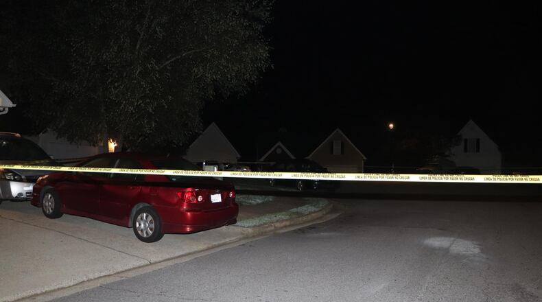 Investigators taped off the scene of a fatal shooting in the Kentshire neighborhood southwest of Lawrenceville in Gwinnett County.