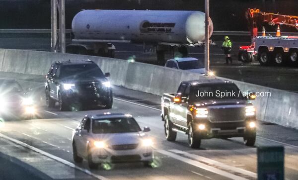 Authorities work to clear a jackknifed propane truck at the Cobb Cloverleaf that jammed the Friday morning drive on I-75 South.
