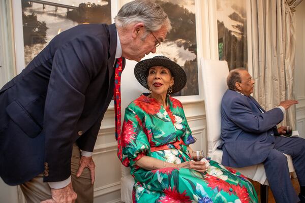 Ambassador Andrew Young, right, is honored at a private patron party in advance of the National Jewish Health’s Forever Young black-tie gala on May 12 to be held at Woodruff Arts Center. Billy Payne, left, the co-chair of the event, chats with Carolyn Young, Andrew’s wife, at the party on Thursday, April 24, 2025. (Jenni Girtman for The Atlanta Journal-Constitution via Amanda Brown Olmstead PR)
