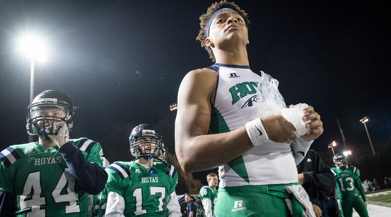 Harrison quarterback Justin Fields holds ice on his hand as he watches from the sideline after coming out of the football game against Dalton during the second half on Thursday, Oct. 19, 2017, in Kennesaw, Ga. (Special to the Atlanta Journal-Constitution, John Amis )