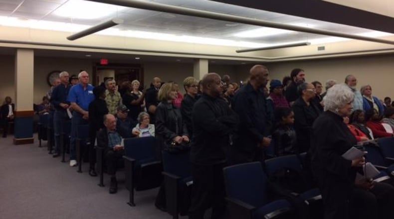 Clayton residents stand during a March 2017 meeting in protest of a County Commission decision a month earlier that stopped CCTV 23 from televising public comments.