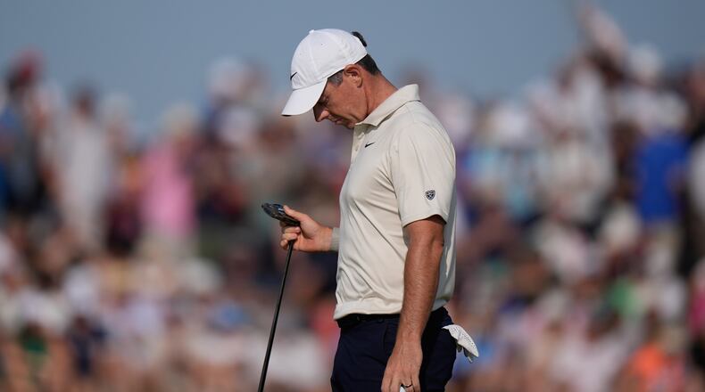 Rory McIlroy of Northern Ireland looks at his club after putting on the 9th green during the first day of the British Open Golf championships at Royal Birkdale golf club, in Southport, England, Thursday, July 16, 2026. (AP Photo/David Goldman)