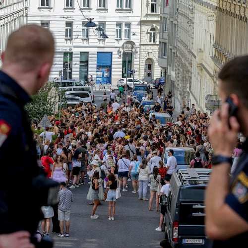 FILE - Austrian police officers watch a gathering of Taylor Swift fans in the city centre in Vienna on Aug. 8, 2024. (AP Photo/Heinz-Peter Bader, File)