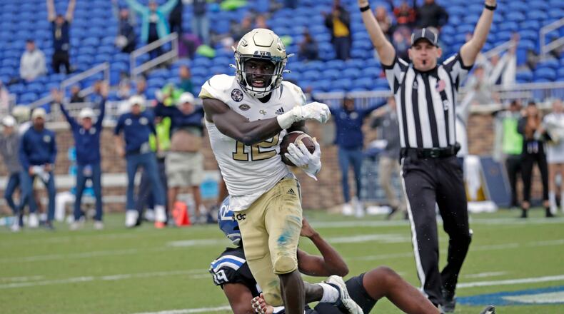 Georgia Tech wide receiver Adonicas Sanders (12) starts to celebrate after he caught a pass for what proved to be the winning touchdown against Duke cornerback Jeremiah Lewis (39) during the second half of an NCAA college football game in Durham, N.C., Saturday, Oct. 9, 2021. (AP Photo/Chris Seward)