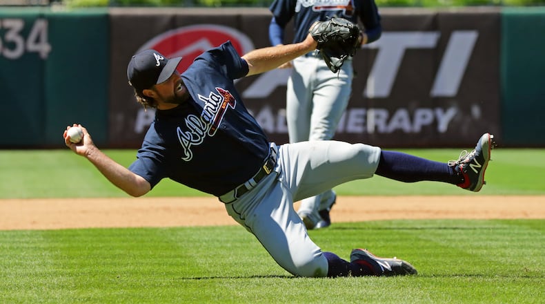PHILADELPHIA, PA - JULY 30: Starting pitcher R.A. Dickey #19 of the Atlanta Braves attempts to make a throw to first base after fielding a ground ball in the fourth inning during a game against the Philadelphia Phillies at Citizens Bank Park on July 30, 2017 in Philadelphia, Pennsylvania. (Photo by Hunter Martin/Getty Images)